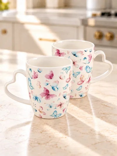 Dúo de tazas Mariposas con asas de corazón